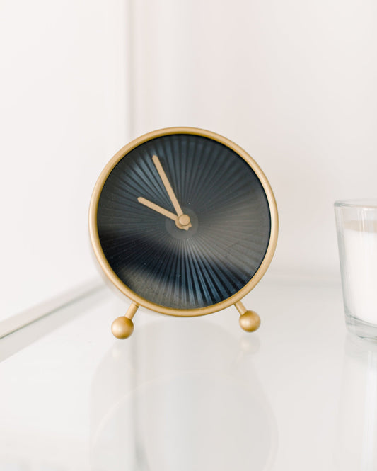 Image of an analog clock, golden. 