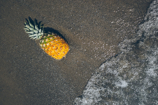 Image of pineapple on sandy beach