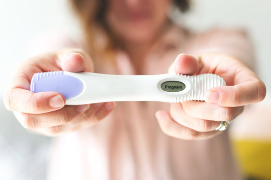 Image of female holding a pregnancy test