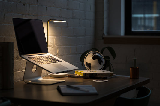 Image of a laptop illuminated on a desk. 